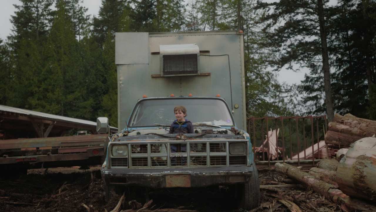 a little boy popping out of the front of a car